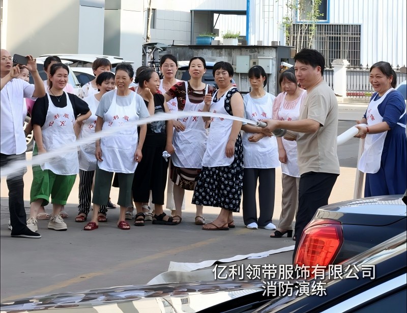 YILI employee operating fire hydrant water hose during factory safety drill